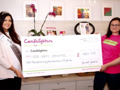 Miss North Yorkshire Anne-Marie O'Donnell presents Events Fundraiser Noemie with the total funds raised by the 2015 competition.